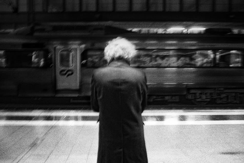 Man and Passing Train by Paulo Abrantes — canvas wall art