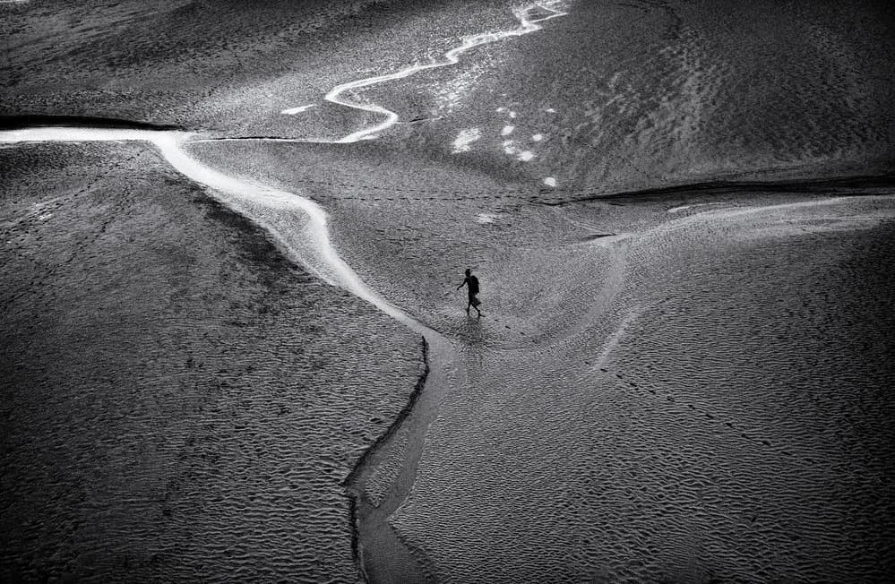Lone Figure Tidal Landscape by Avishek Das — canvas wall art