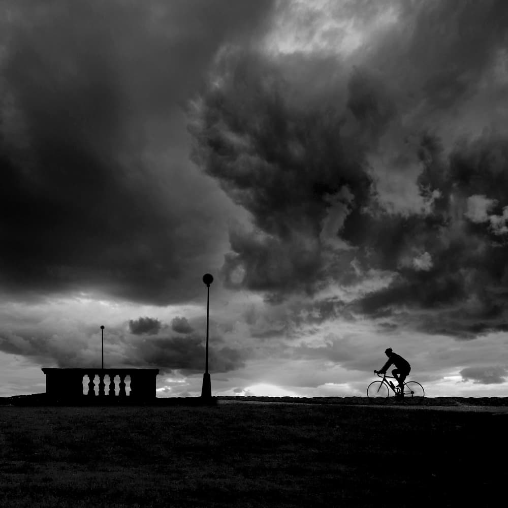 Cyclist Under Stormy Sky by George Digalakis — canvas wall art