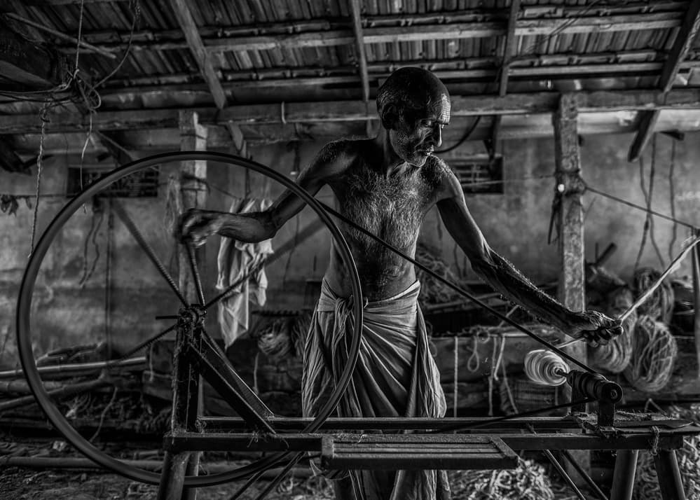 Old Man Spinning Fiber by Marco Tagliarino — canvas wall art