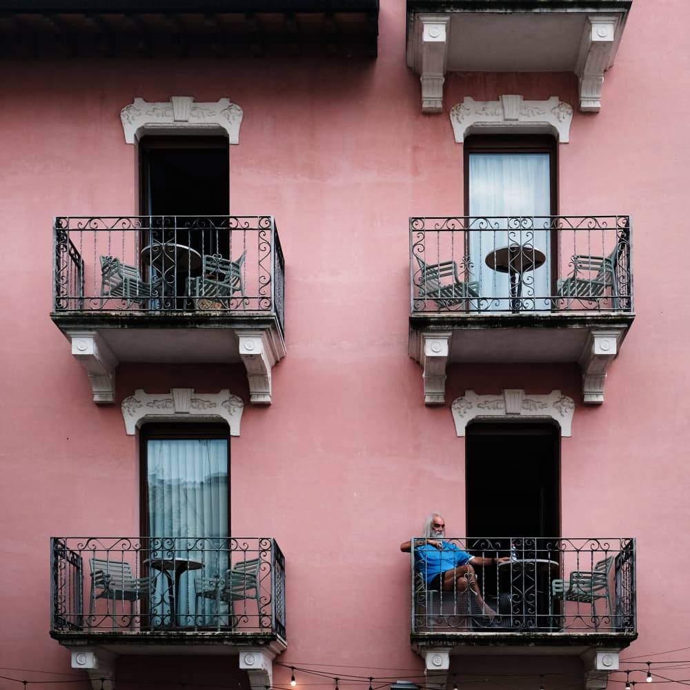 Man on Pink Balcony by Elena Raceala — canvas wall art