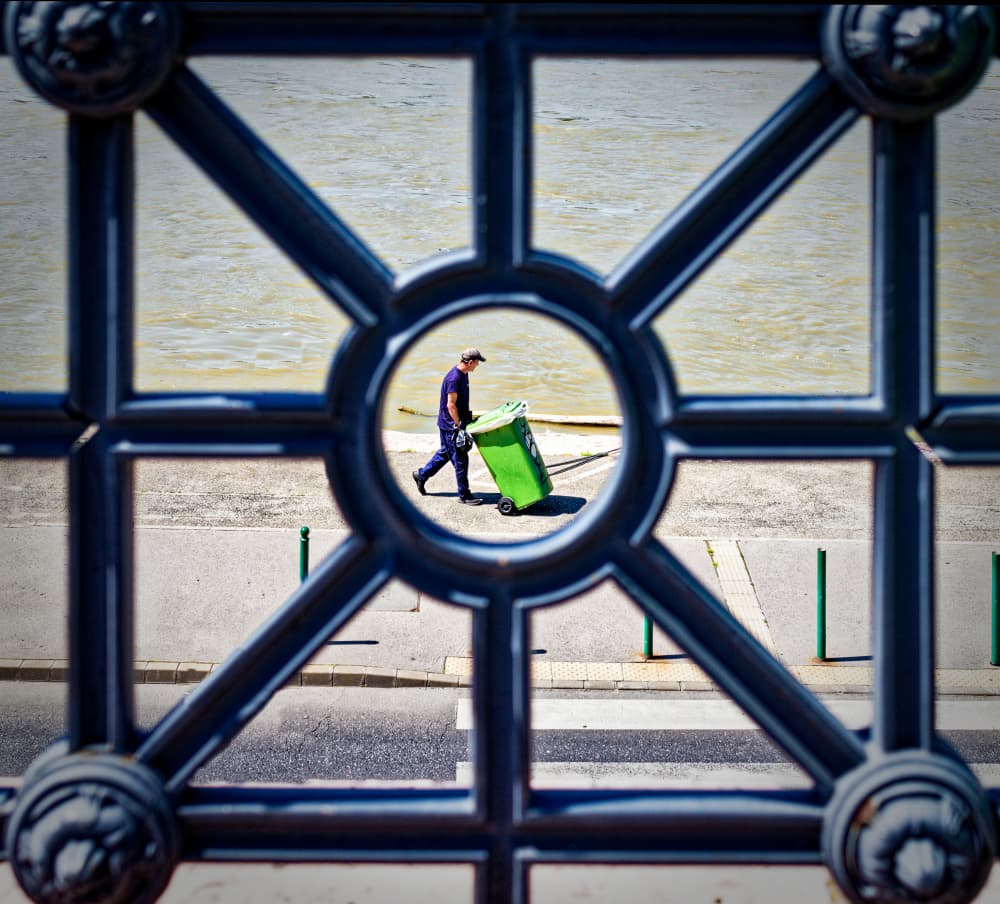 Man Pushing Green Bin by Andreas Timar — canvas wall art