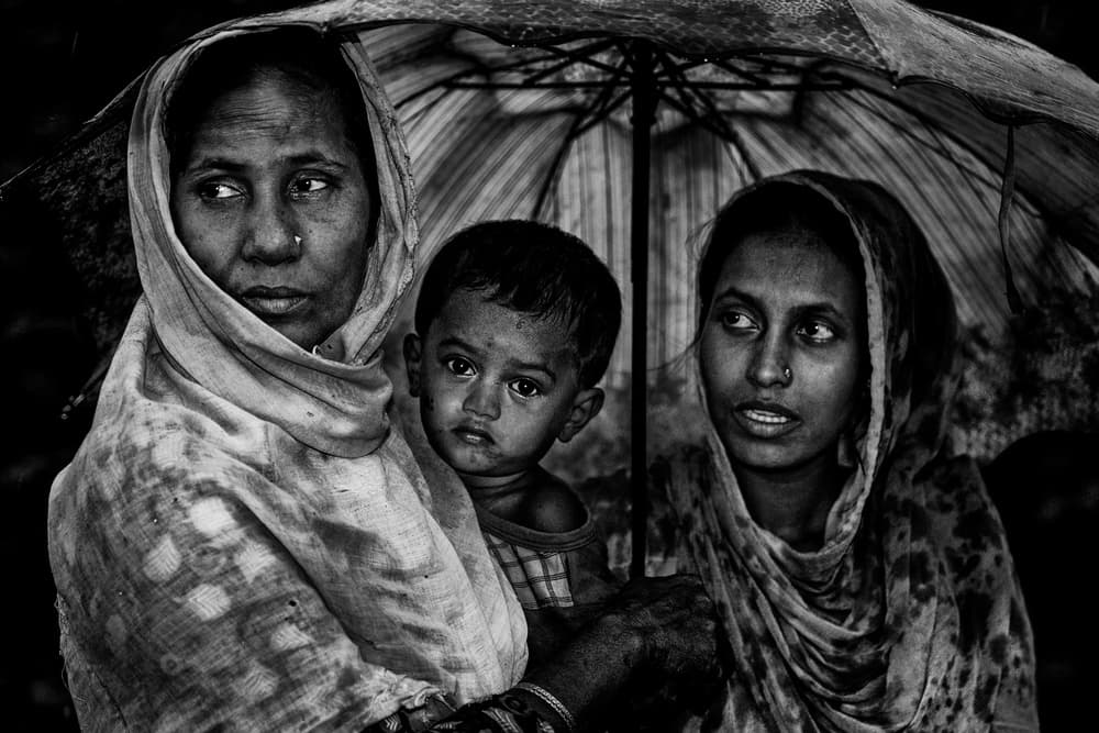 Family Under Umbrella by Joxe Inazio Kuesta Garmendia — canvas wall art