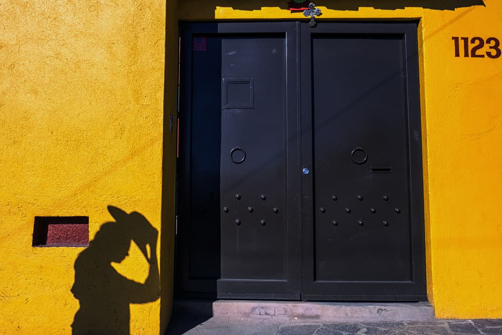Hat Shadow on Yellow Wall by Ali Khataw — canvas wall art