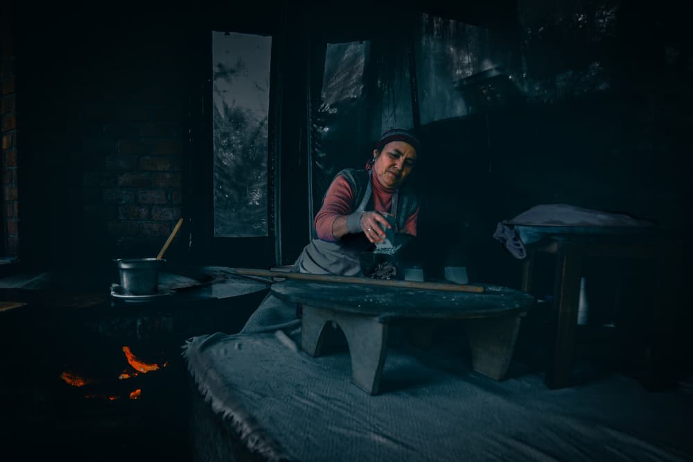 Woman Cooking By Fire by Rob Li — canvas wall art