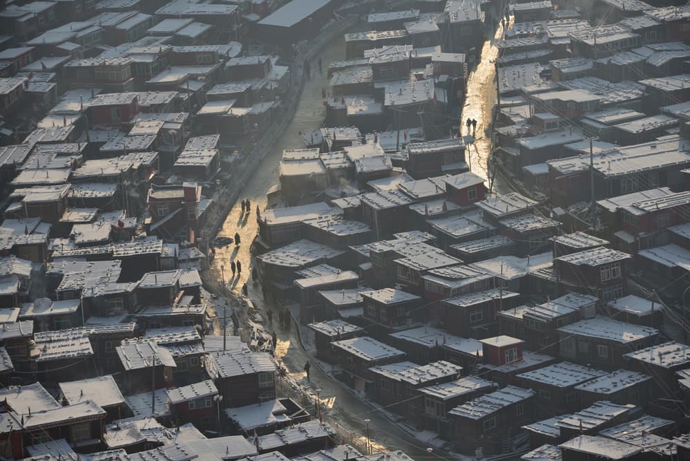 Sunlit Winter Village by Sarawut Intarob — canvas wall art