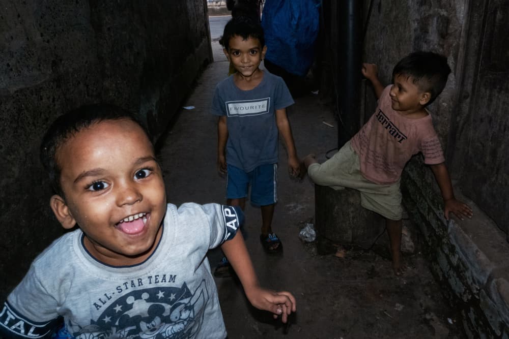 Smiling Boys Alleyway by Kuntal Biswas — canvas wall art