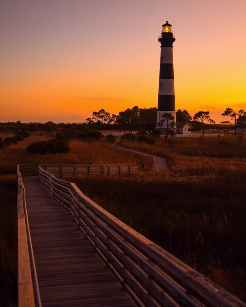 Marsh Path Lighthouse Sunset by Del Mundo Imagery — canvas wall art