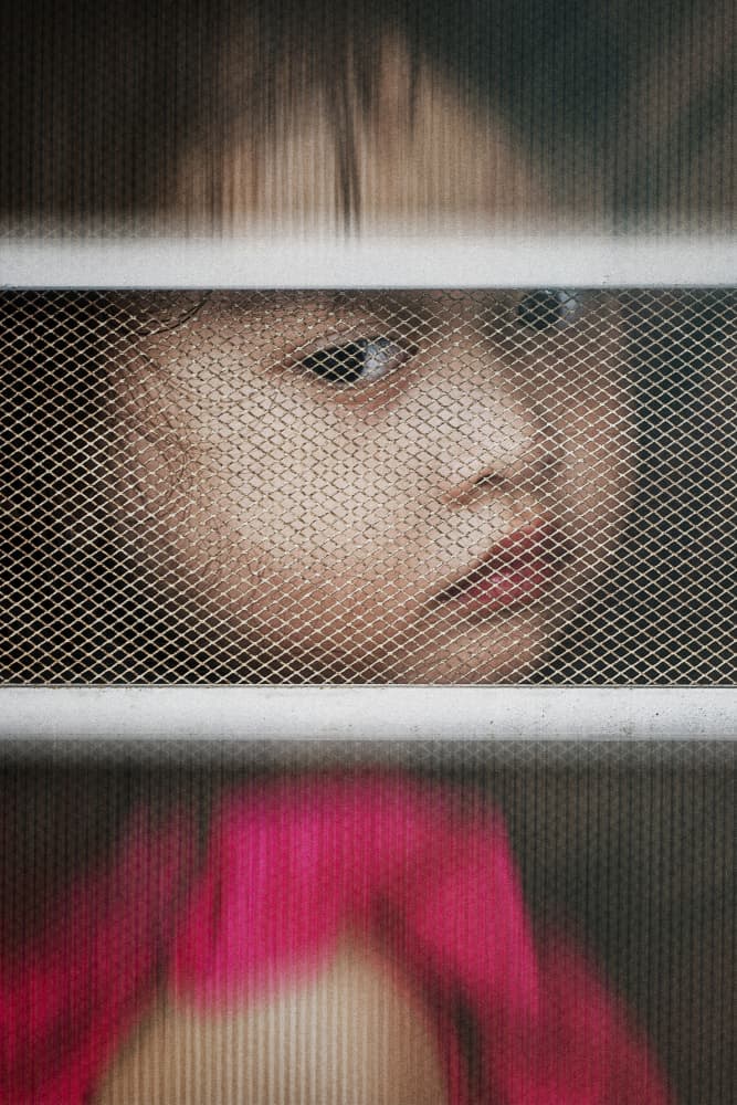 Child Behind Mesh by Andi Halil — canvas wall art