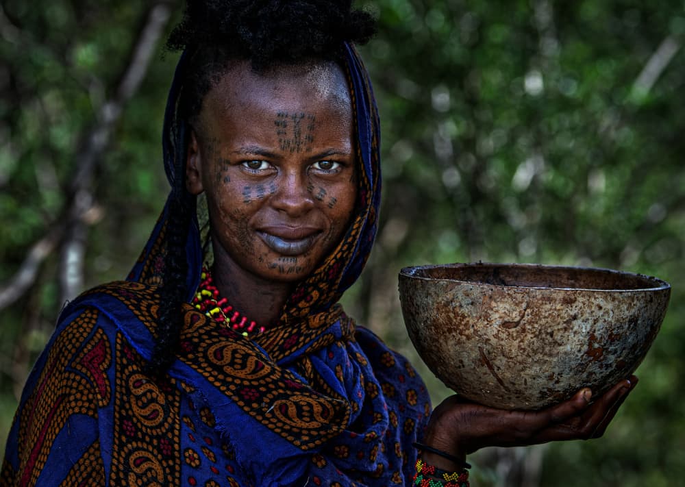 Tribal Woman Holding Bowl by Joxe Inazio Kuesta Garmendia — canvas wall art