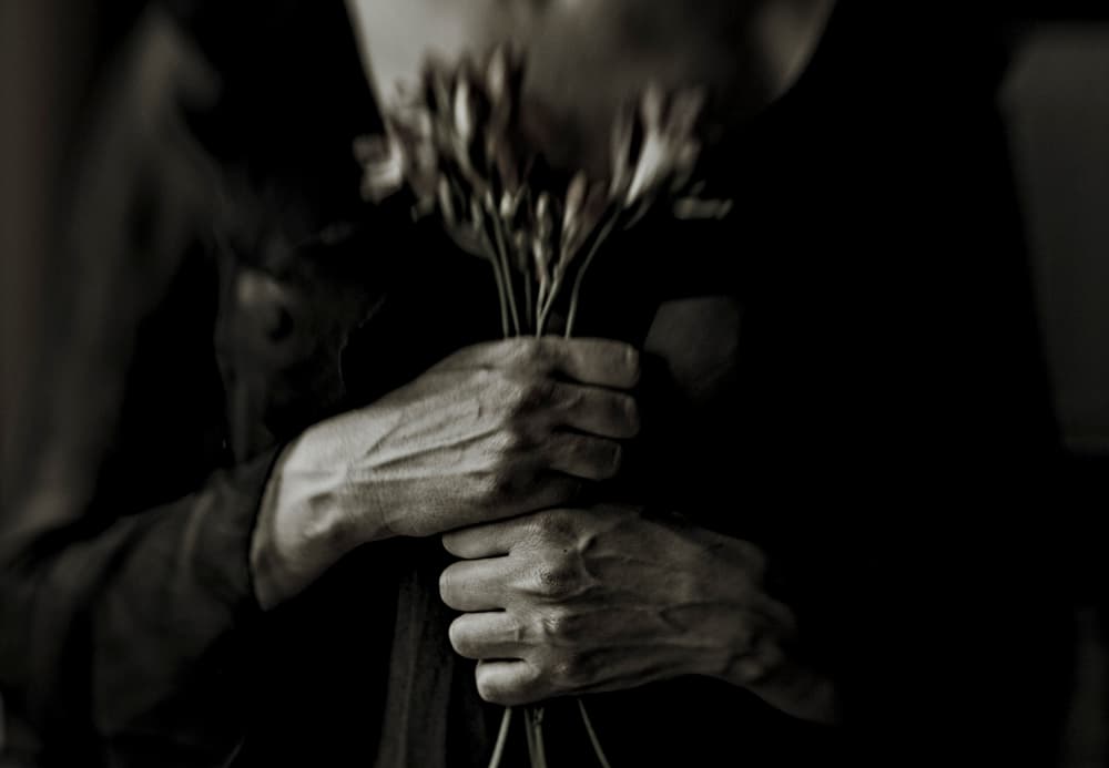 Melancholic Hands Holding Flowers by Bogdan Bouşcă — canvas wall art