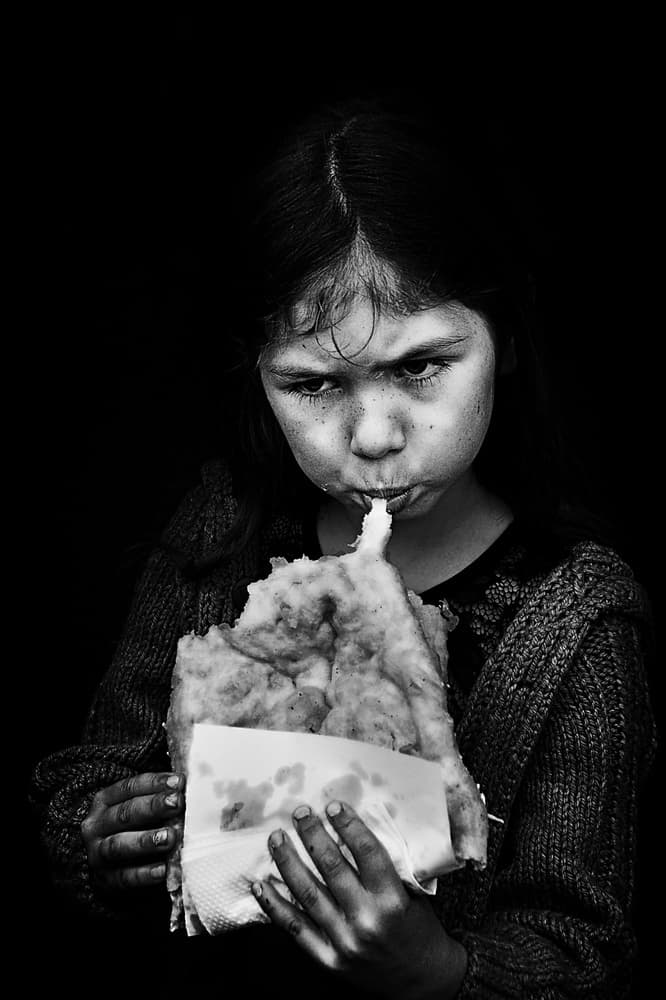Gritty Child Eating Food by Nicoleta Gabor — canvas wall art
