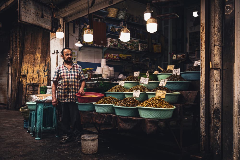 Market Olive Vendor by Marco Tagliarino — canvas wall art