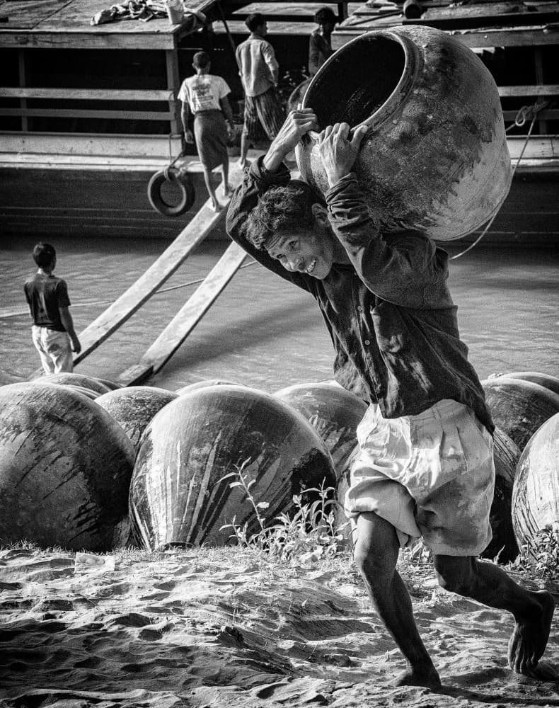Man Carrying River Pot by John Yuk Kong Chung — canvas wall art