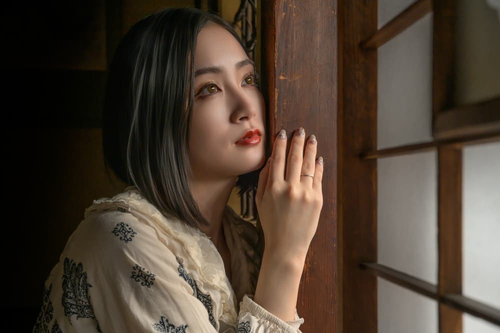Pensive Asian Woman By Window by GABA — canvas wall art