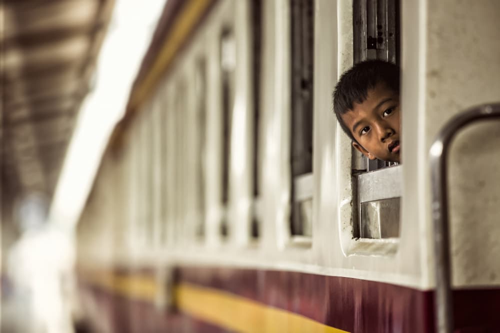 Curious Boy Train Window by Milton Louiz — canvas wall art