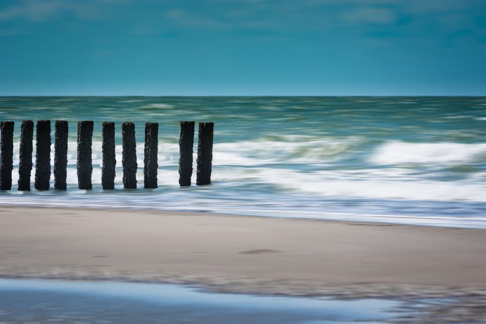 Serene Beach Groynes by Bernardine de Laat — canvas wall art