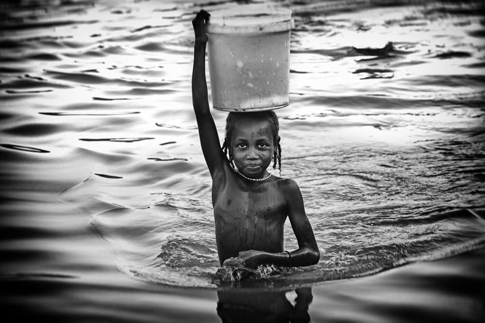 Girl Carrying Water by Elena Molina — canvas wall art