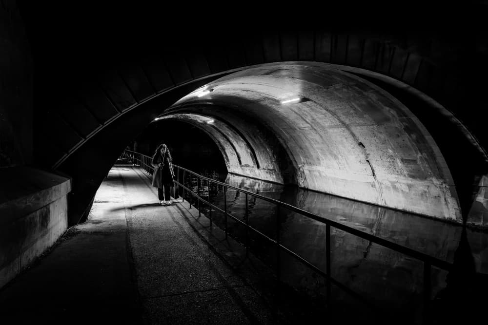 Solitary Woman Under Arch by Adam Dauria ☂ — canvas wall art