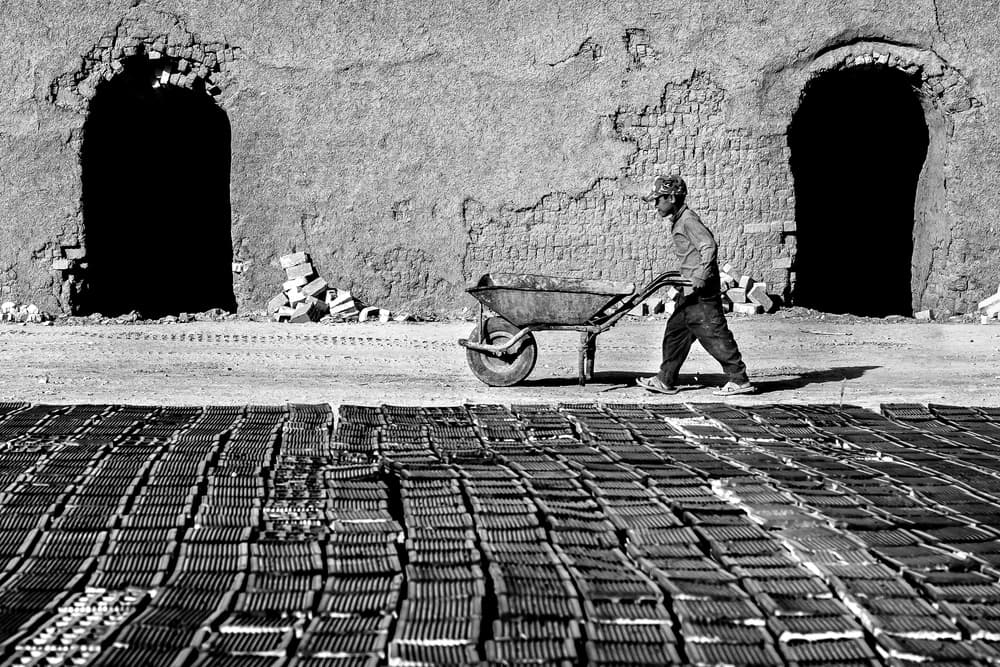 Man Pushing Bricks by Mohammadreza Momeni — canvas wall art