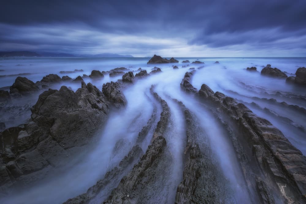 Serene Coastal Rock Flow by Carlos F. Turienzo — canvas wall art