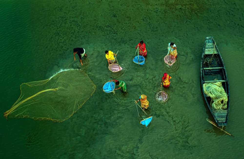River Fishermen Casting Nets by Ajit Kumar Majhi — canvas wall art