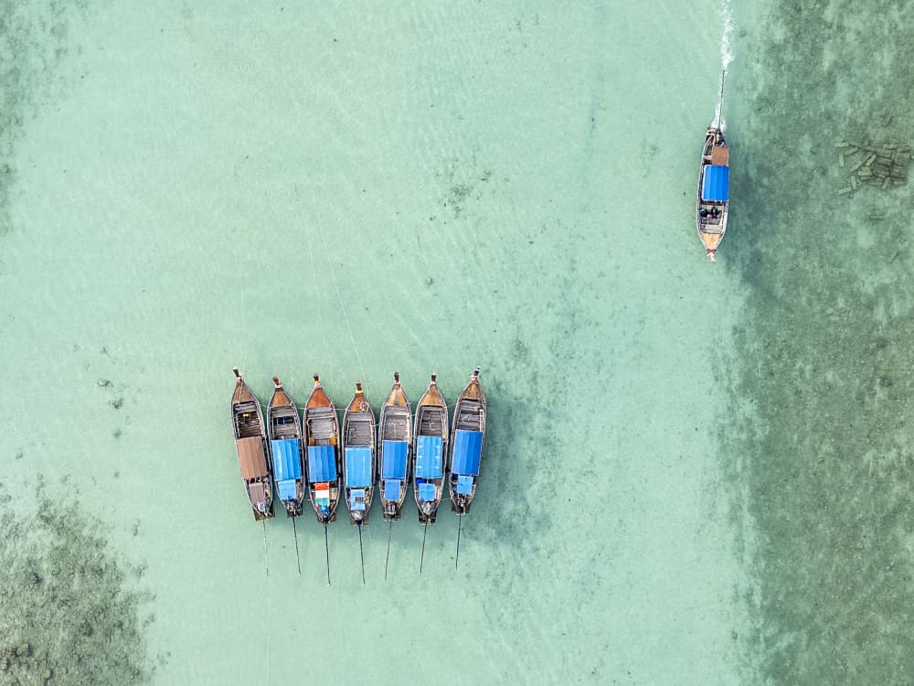 Longtail Boats Paradise by Jose Curto — canvas wall art
