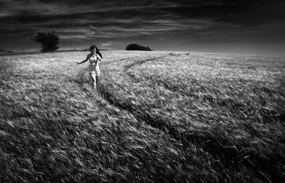 Woman Running Wheat Field by Peter Davidson — canvas wall art