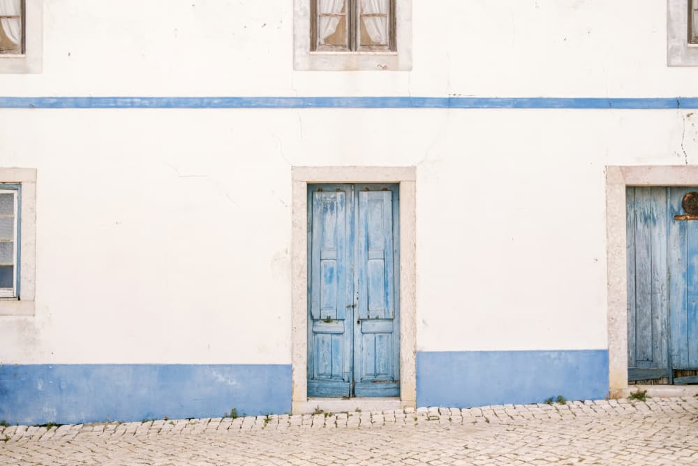 Ericeira Blue Door by Raisa Zwart — canvas wall art