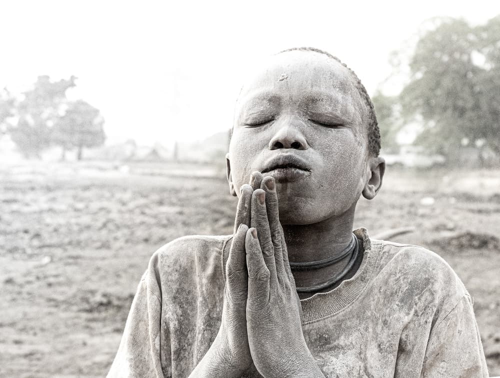 Young Boy Praying by Elena Molina — canvas wall art