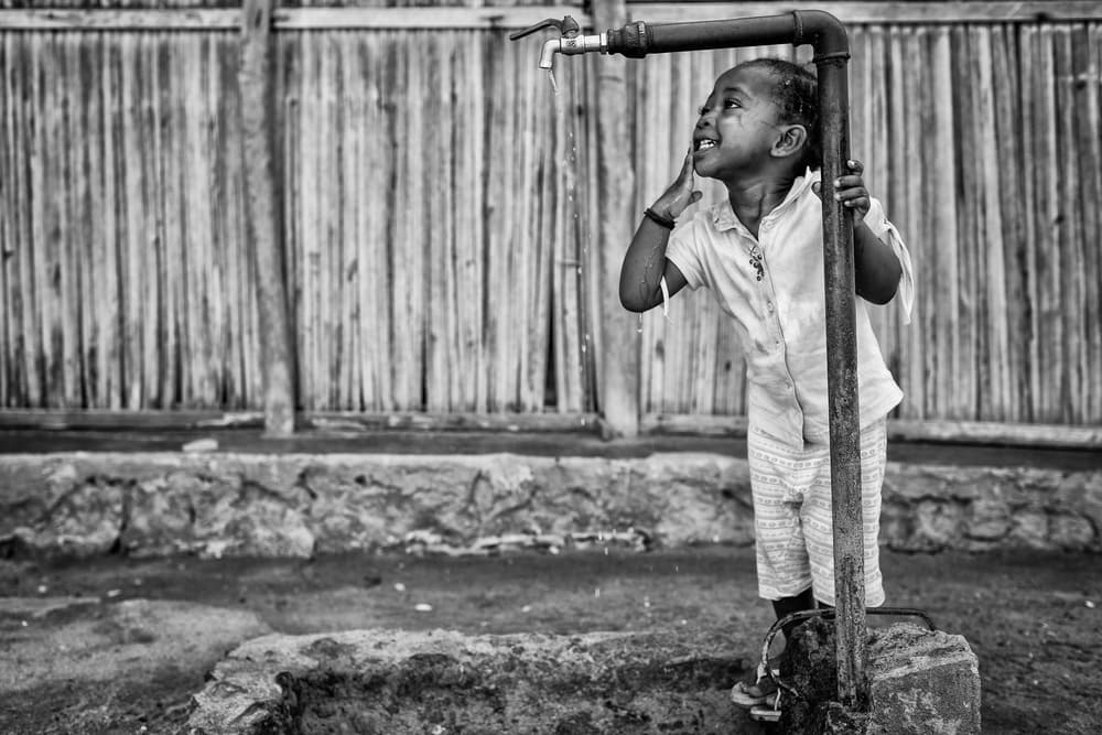 Happy Child Drinking Water by Gloria Salgado Gispert — canvas wall art