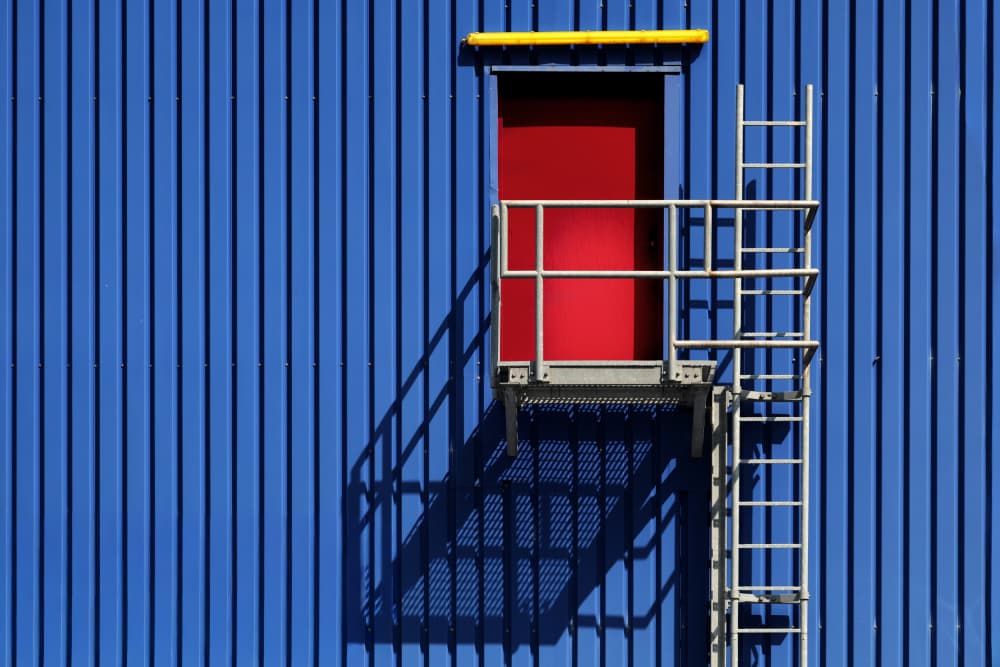 Vibrant Blue Wall Red Door by Hans-Wolfgang Hawerkamp — canvas wall art