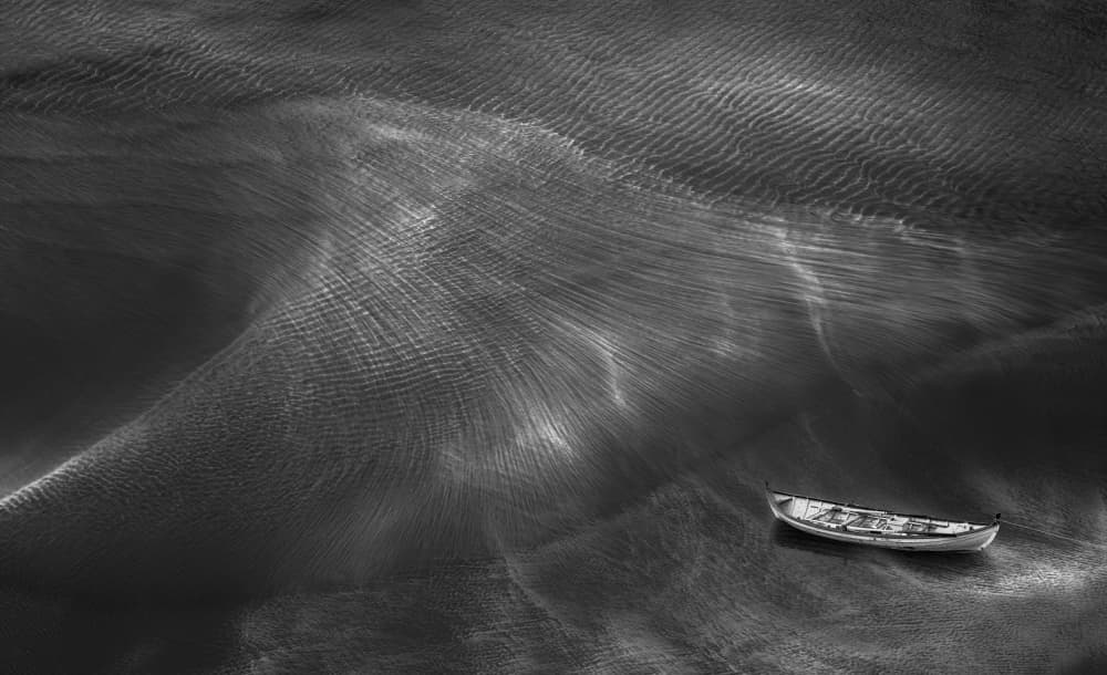 Solitary Boat Rippled Water by Aidong Ning — canvas wall art