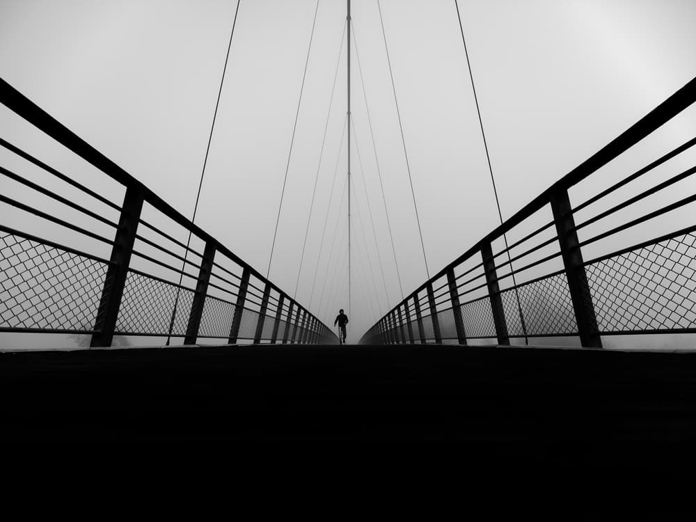 Lone Figure on Bridge by Marius Surleac — canvas wall art