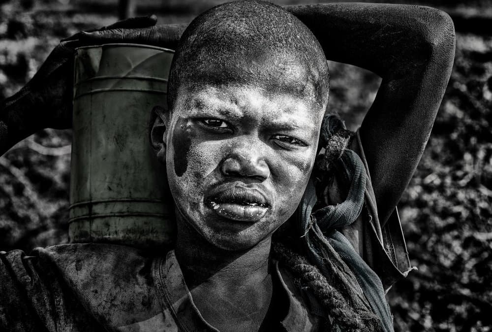 African Boy Carrying Water by Joxe Inazio Kuesta Garmendia — canvas wall art