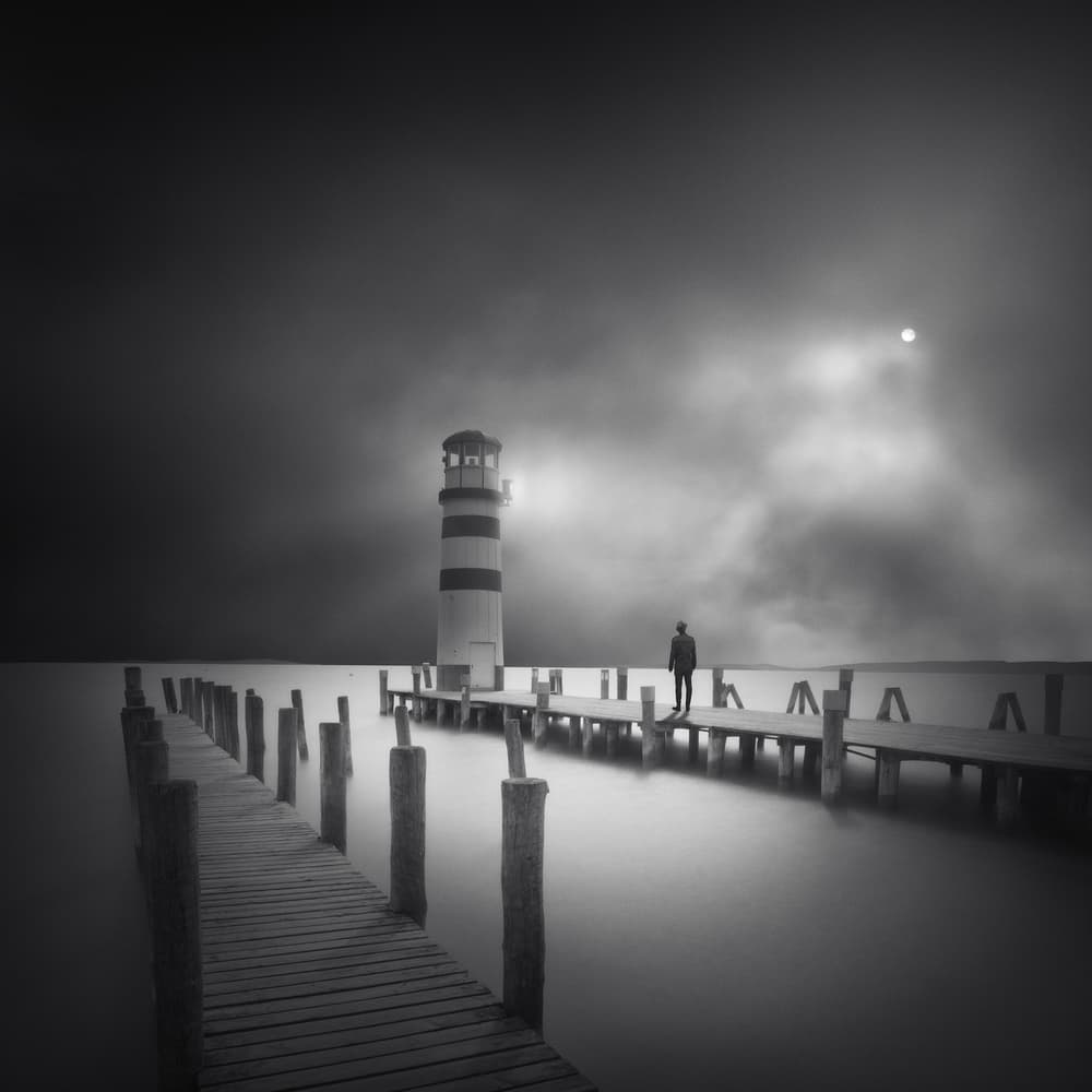 Lone Figure Lighthouse Pier by Martin Marcisovsky — canvas wall art