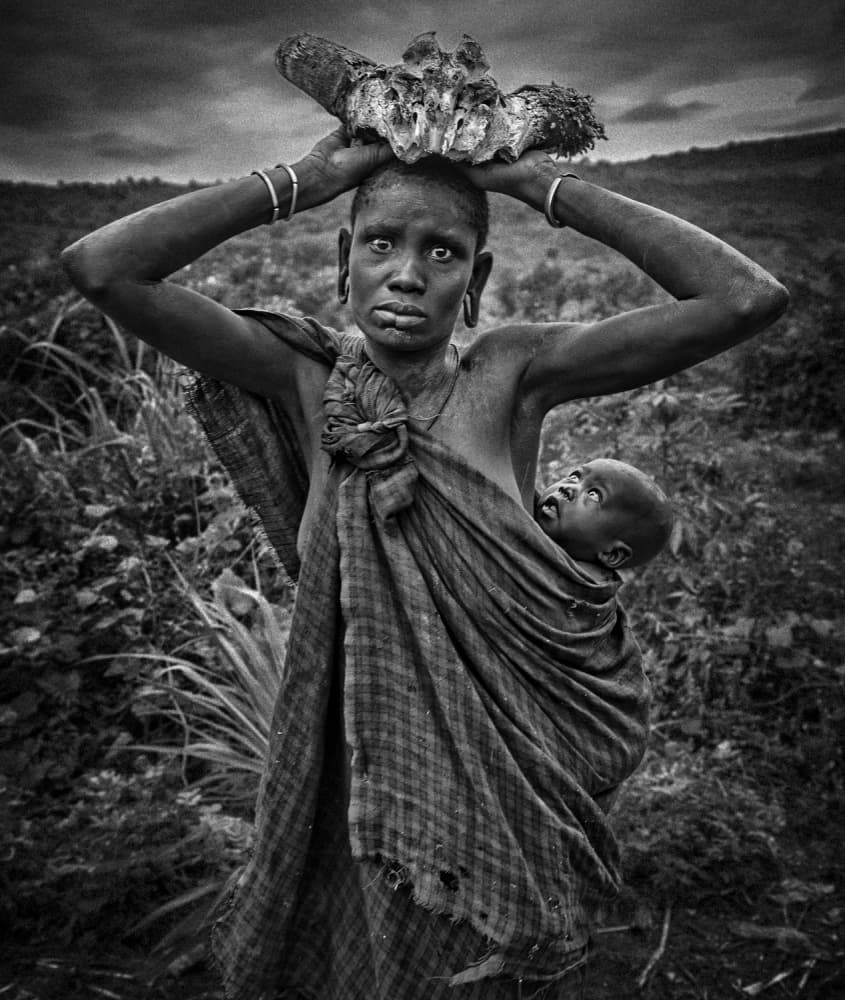 Tribal Woman Carrying Skull by Joxe Inazio Kuesta Garmendia — canvas wall art