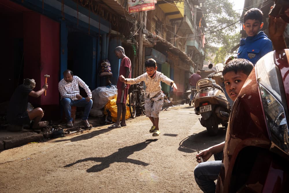 Boy Jumping Street Scene by Kuntal Biswas — canvas wall art