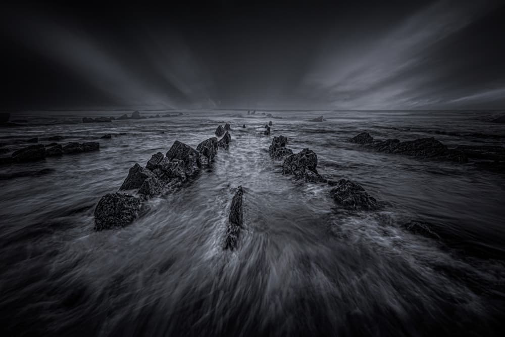 Moody Ocean Rocks by Yuan Su — canvas wall art
