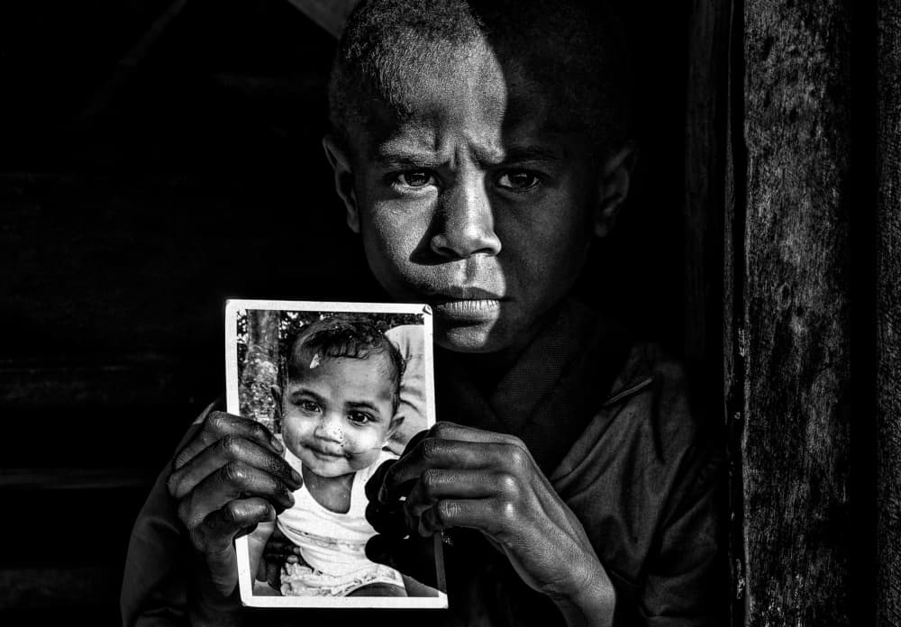 Serious Boy Holds Photo by Joxe Inazio Kuesta Garmendia — canvas wall art