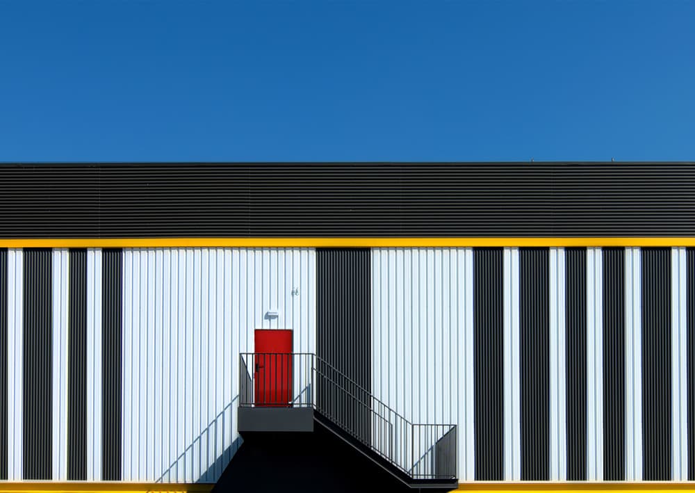 Striped Building Red Door by Alfonso Novillo — canvas wall art
