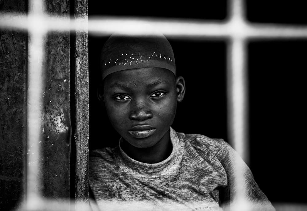 Boy's Intense Window Gaze by Joxe Inazio Kuesta Garmendia — canvas wall art