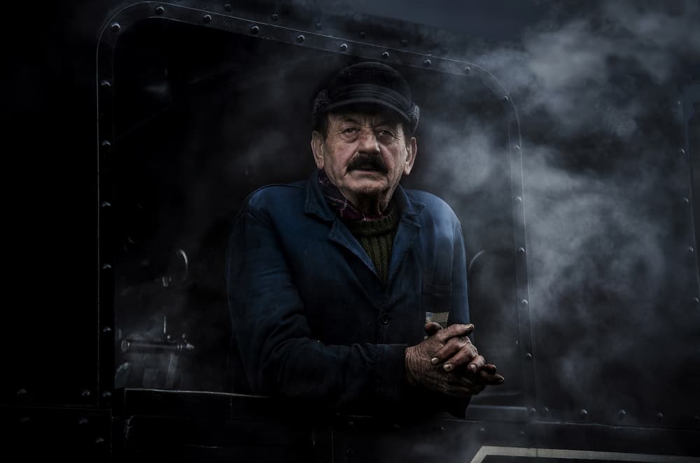 Pensive Train Engineer by Irene Perovich — canvas wall art