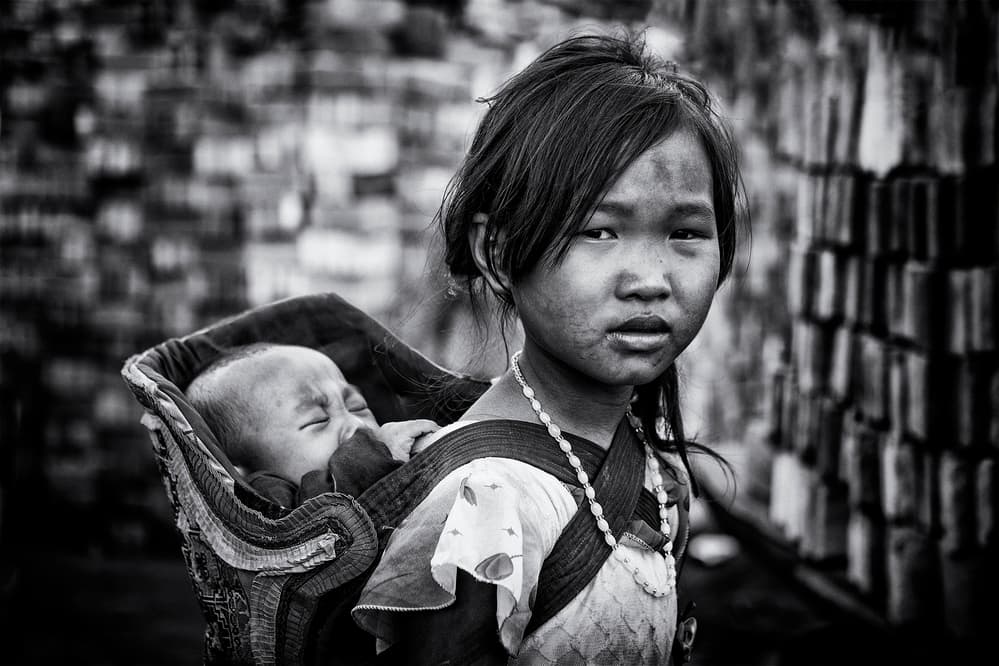 Young Girl Carrying Baby by Ahmed Abdulazim — canvas wall art