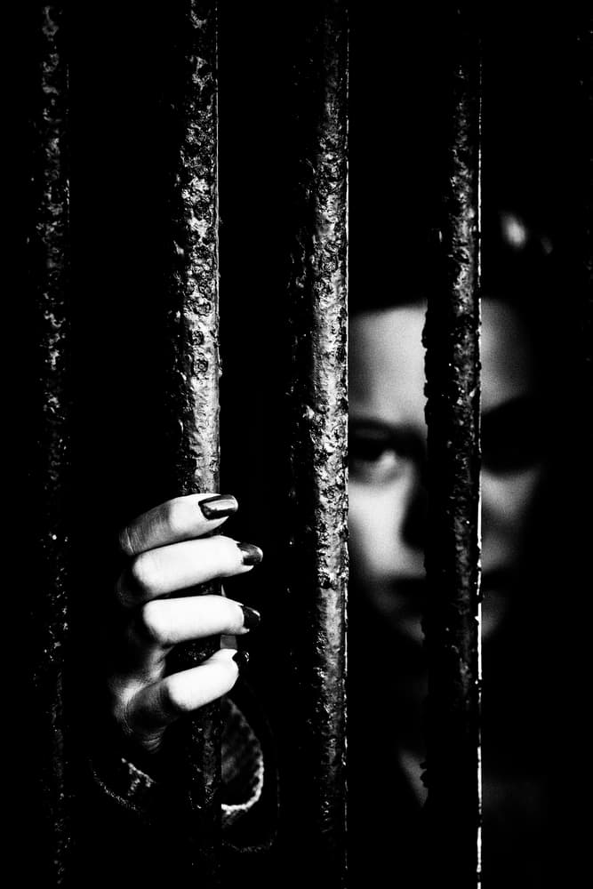 Trapped Woman Behind Bars by Jacob Tuinenga — canvas wall art