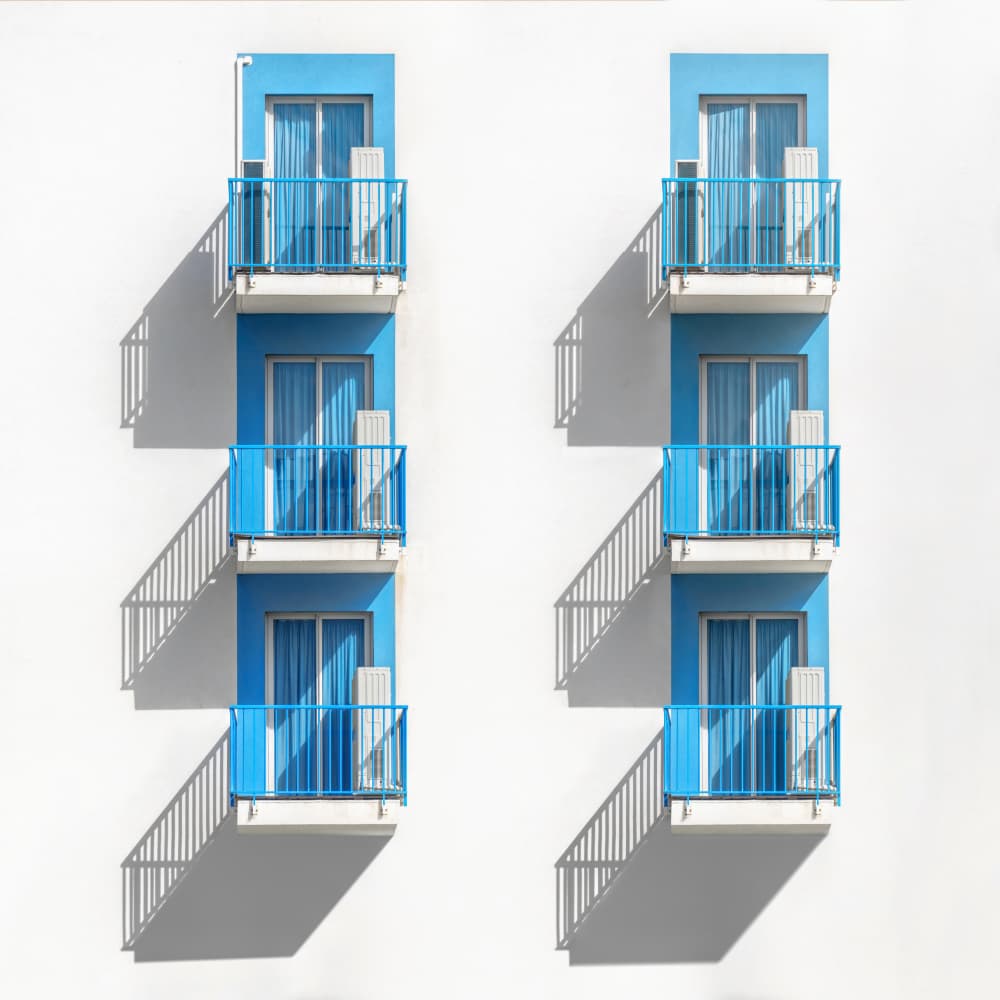 Symmetrical Blue Balconies by Andrea Comari — canvas wall art