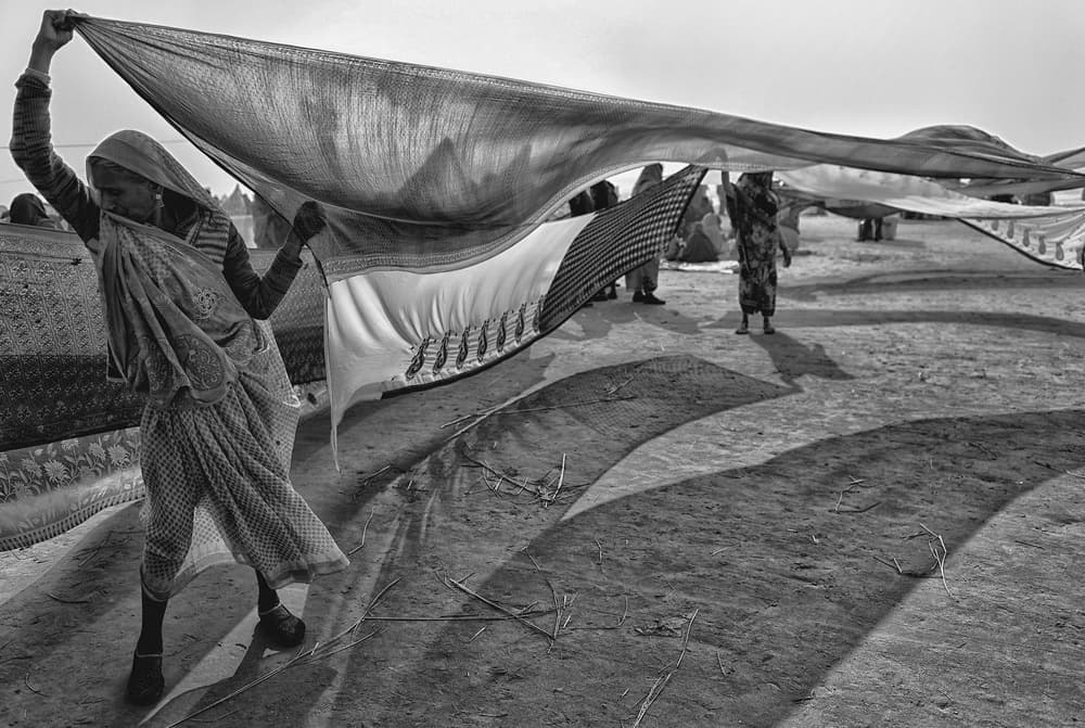 Women Spreading Fabric by Avishek Das — canvas wall art