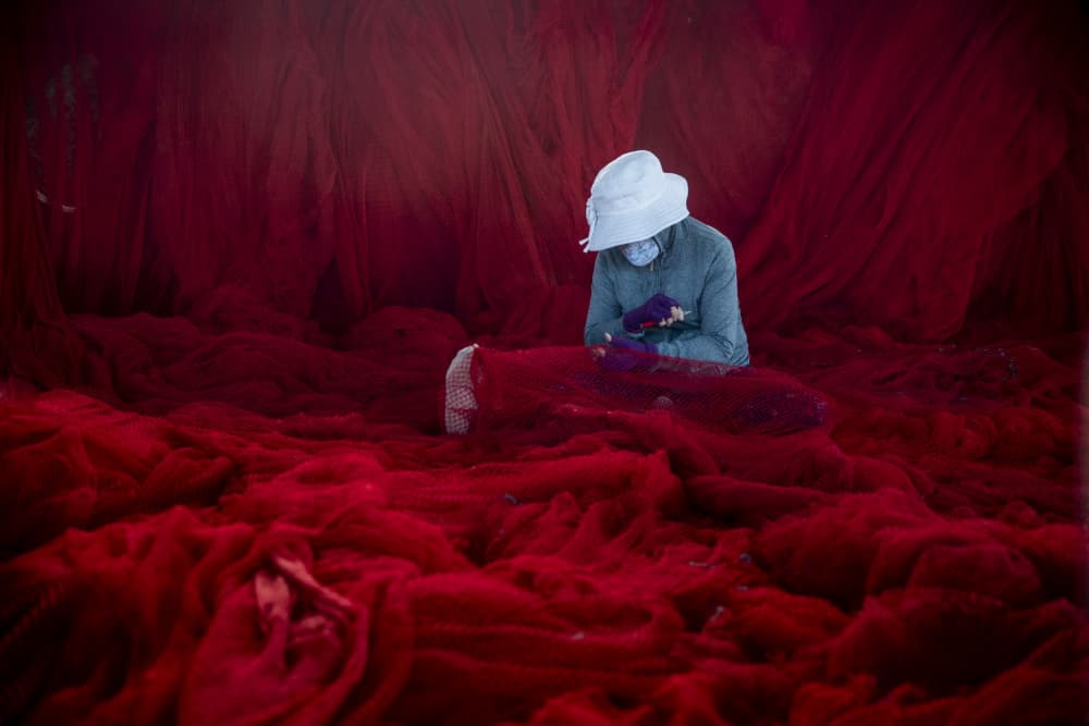 Mending Red Nets by Nguyen Tan Tuan — canvas wall art