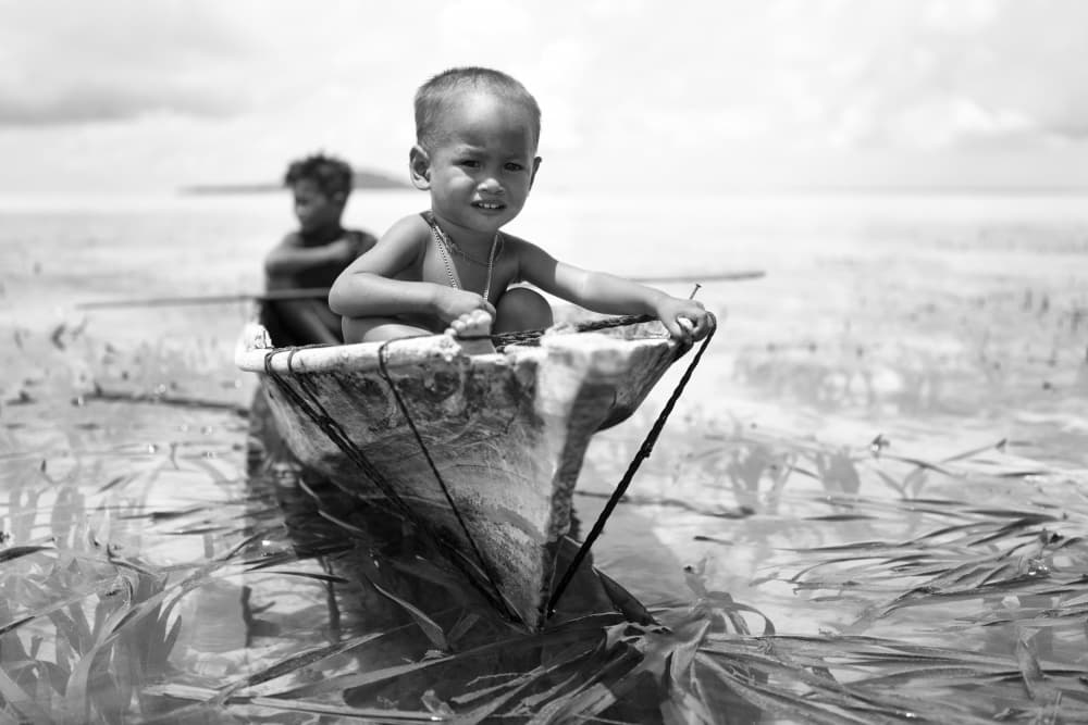 Smiling Child In Boat by Kieron Long — canvas wall art