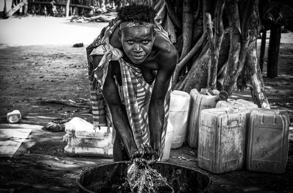 African Woman Washing by Joxe Inazio Kuesta Garmendia — canvas wall art